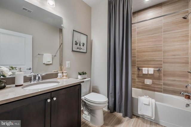 full bathroom featuring toilet, shower / bathtub combination with curtain, and vanity