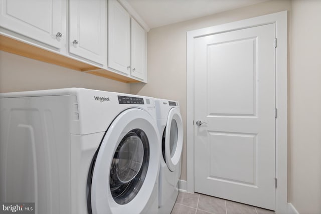 laundry room featuring light tile patterned floors, cabinets, and independent washer and dryer