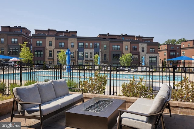 view of patio / terrace with an outdoor living space with a fire pit and a community pool