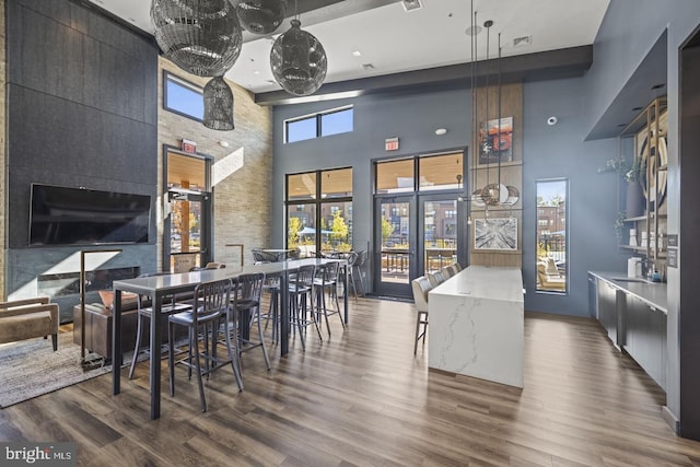 kitchen featuring a high ceiling, dark hardwood / wood-style flooring, and pendant lighting