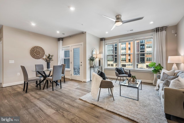 living room with ceiling fan and hardwood / wood-style floors