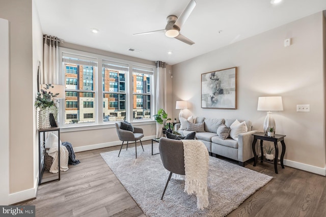 living room featuring hardwood / wood-style floors, ceiling fan, and plenty of natural light