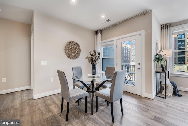 dining area with hardwood / wood-style floors