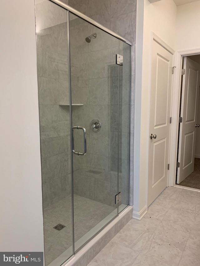 bathroom with a shower with shower door