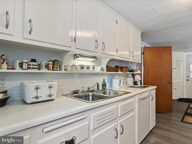 kitchen with white cabinets, dishwasher, sink, and hardwood / wood-style flooring