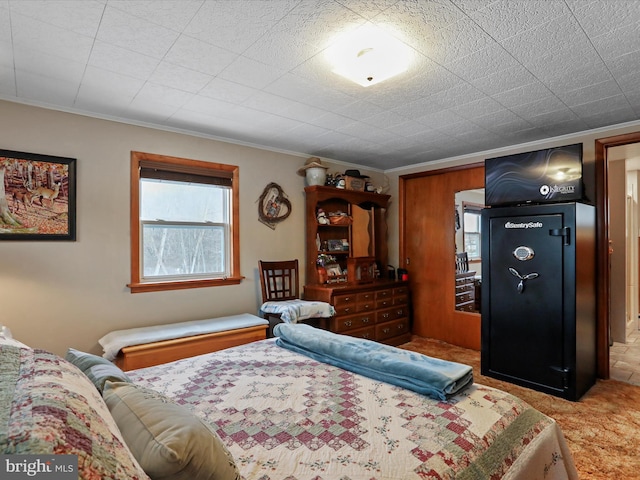 carpeted bedroom with ornamental molding