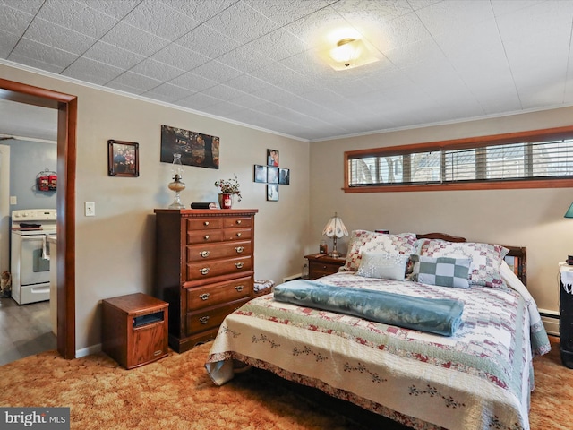 carpeted bedroom featuring a baseboard heating unit and crown molding