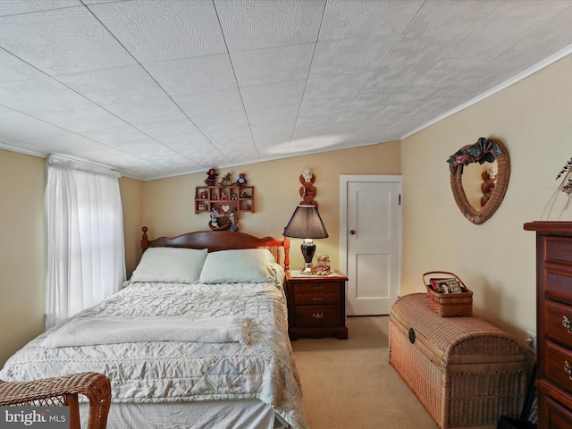 bedroom featuring ornamental molding and light colored carpet