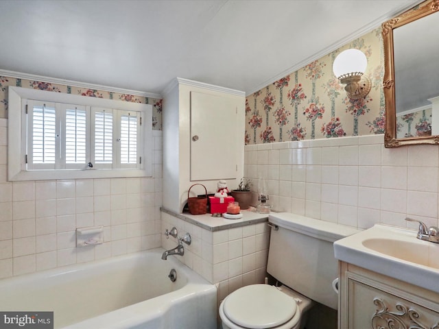 bathroom with tile walls, ornamental molding, toilet, a washtub, and vanity