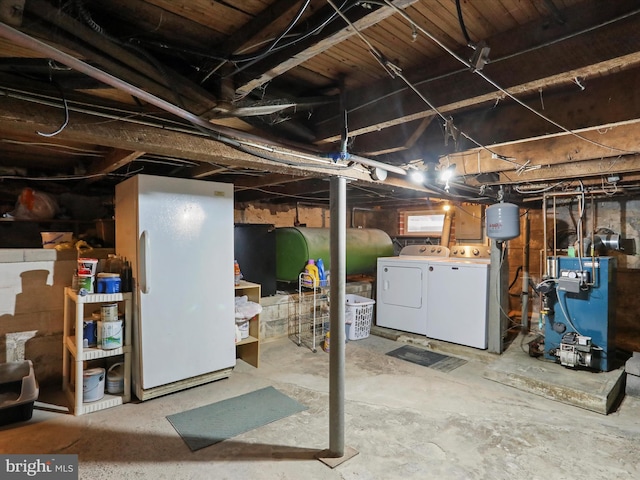 basement with white refrigerator and washing machine and clothes dryer