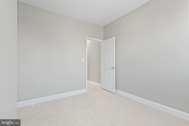 unfurnished room featuring light colored carpet