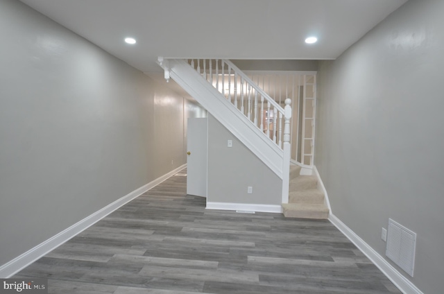 stairway featuring hardwood / wood-style flooring