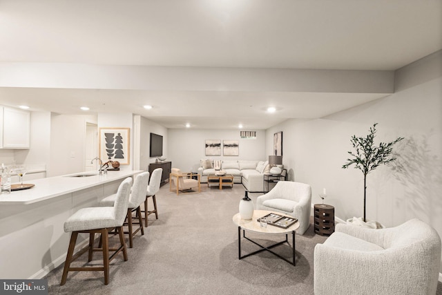 living room with light carpet and sink