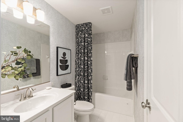 full bathroom featuring tile patterned flooring, shower / bath combo with shower curtain, vanity, and toilet