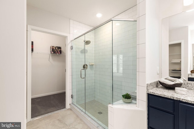 bathroom with vanity, tile patterned flooring, and a shower with shower door