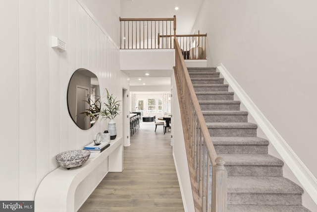 stairway with hardwood / wood-style floors