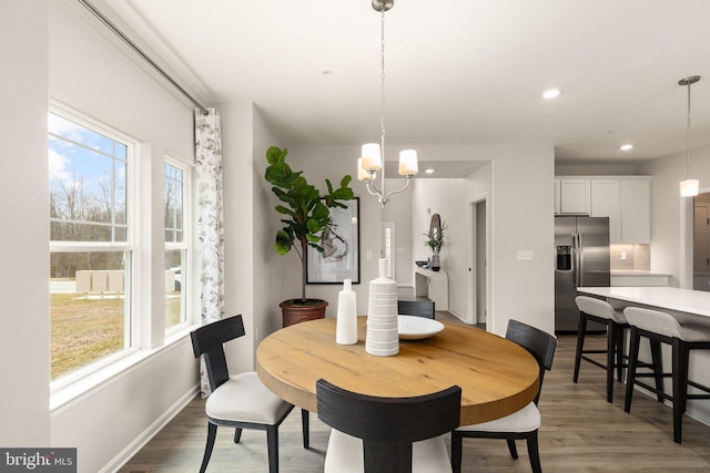 dining room with a notable chandelier and dark wood-type flooring