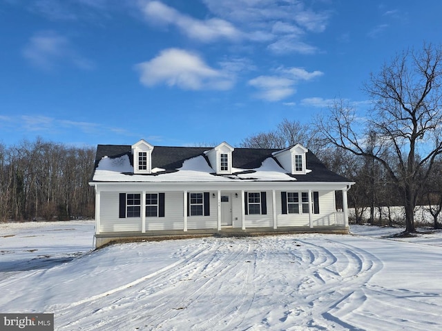 cape cod-style house featuring covered porch