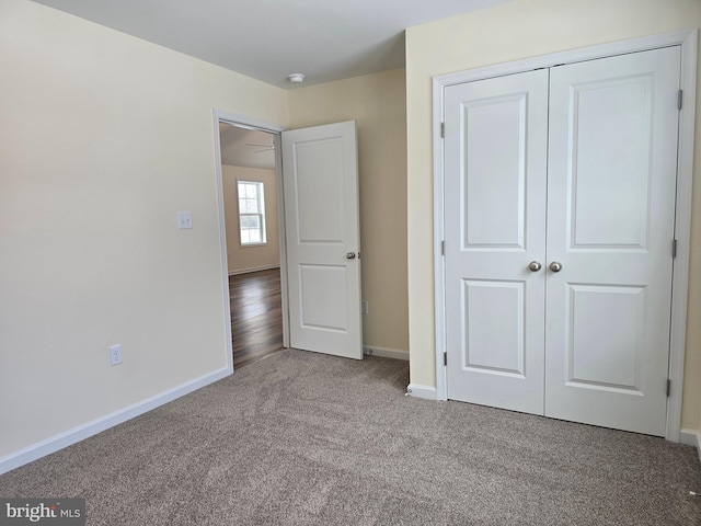 unfurnished bedroom featuring carpet and a closet