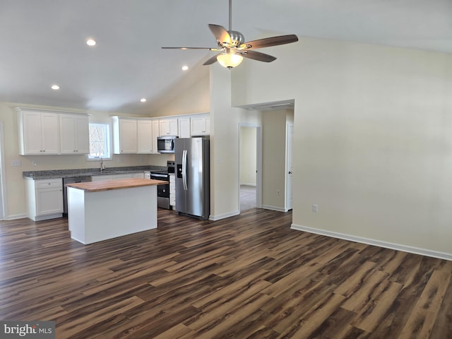 kitchen featuring white cabinets, appliances with stainless steel finishes, wooden counters, and dark hardwood / wood-style floors