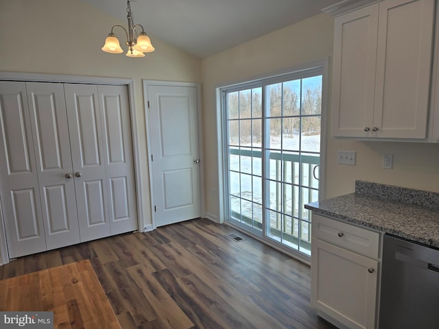 kitchen with white cabinets, decorative light fixtures, an inviting chandelier, light stone counters, and stainless steel dishwasher