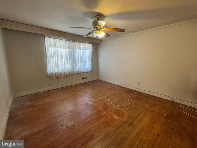 spare room with wood-type flooring and ceiling fan