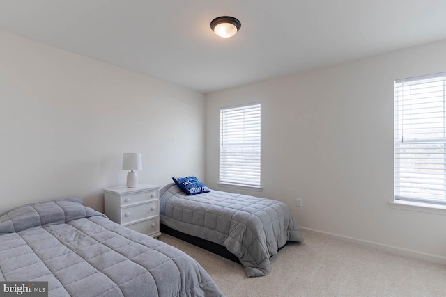 bedroom featuring light colored carpet