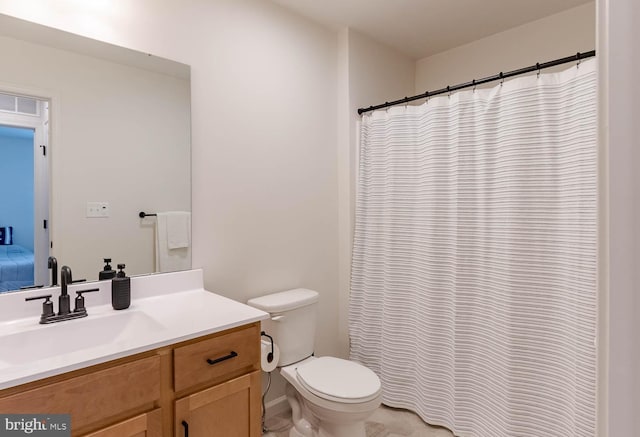 bathroom featuring toilet and vanity