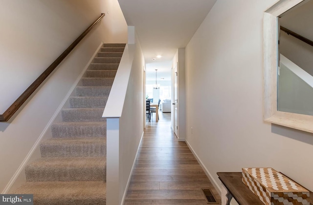 hallway with hardwood / wood-style flooring