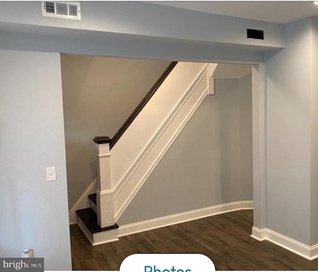 stairs featuring hardwood / wood-style flooring