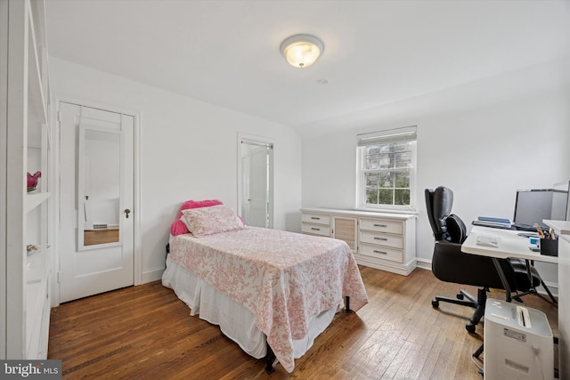 bedroom featuring baseboards and wood-type flooring