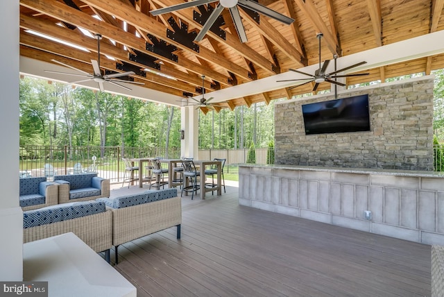 wooden deck featuring ceiling fan and outdoor lounge area