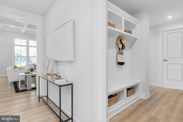 mudroom with light hardwood / wood-style flooring, coffered ceiling, and beamed ceiling