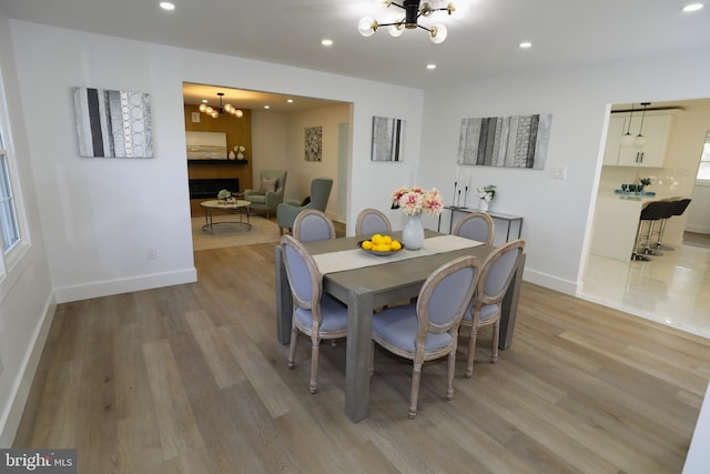 dining room featuring a notable chandelier and light hardwood / wood-style floors