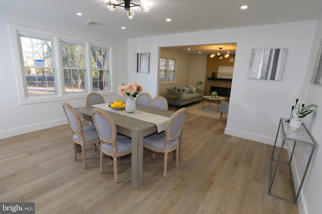 dining room featuring a notable chandelier and light hardwood / wood-style floors