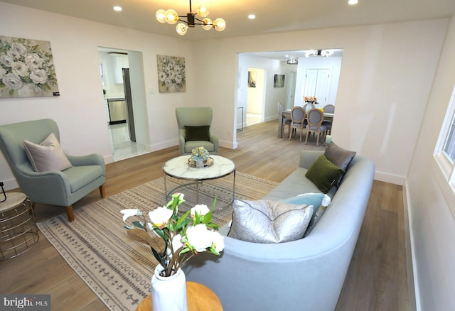 living room with a notable chandelier and wood-type flooring