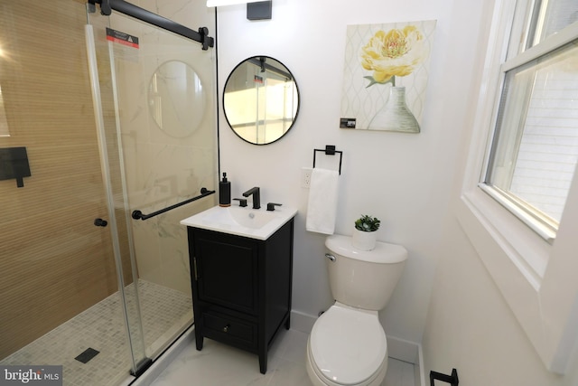 bathroom with a shower with door, tile patterned floors, vanity, and toilet