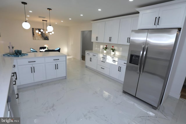 kitchen featuring pendant lighting, white cabinetry, decorative backsplash, and stainless steel refrigerator with ice dispenser