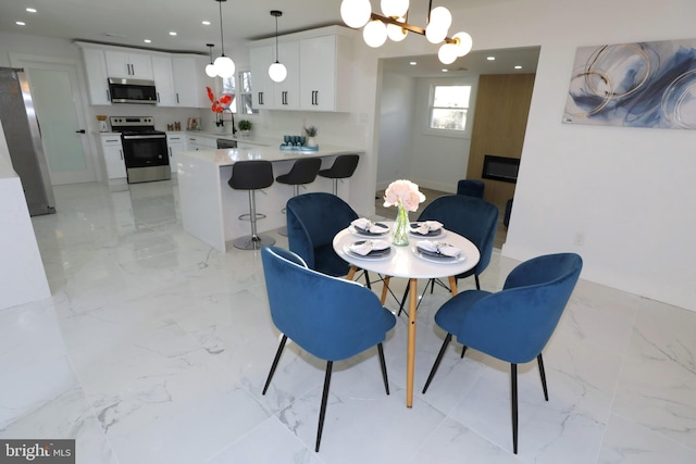 dining space with an inviting chandelier