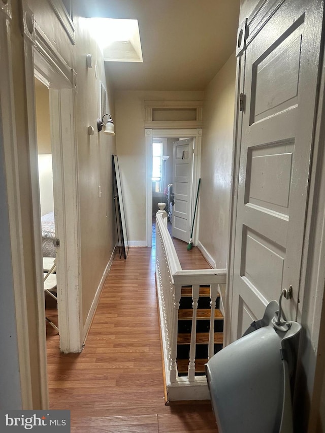 corridor featuring wood-type flooring