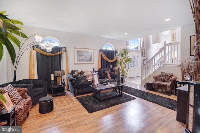 living room featuring a notable chandelier and light hardwood / wood-style floors