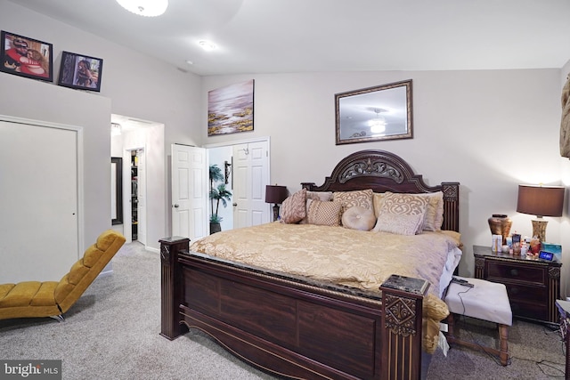 carpeted bedroom with lofted ceiling