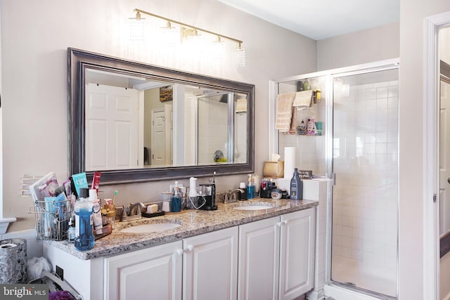 bathroom featuring vanity and a shower with door