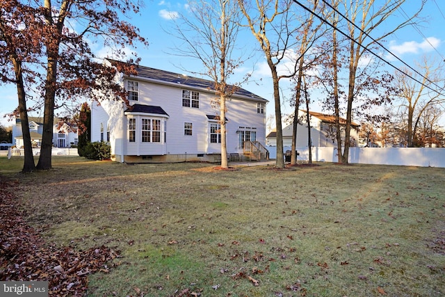 rear view of house with a yard