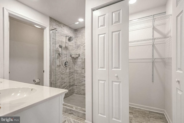 bathroom with vanity and a shower with door