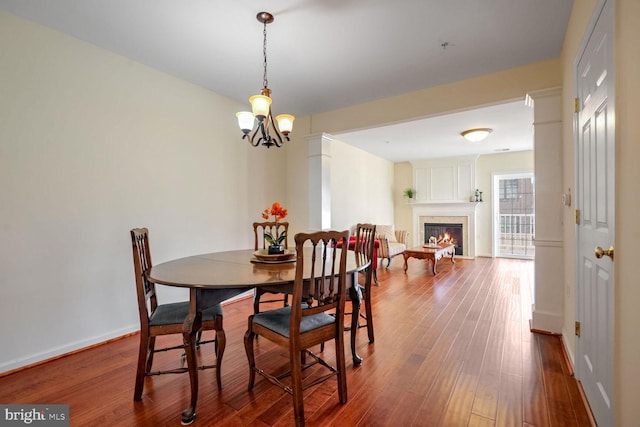 dining room with an inviting chandelier and hardwood / wood-style flooring