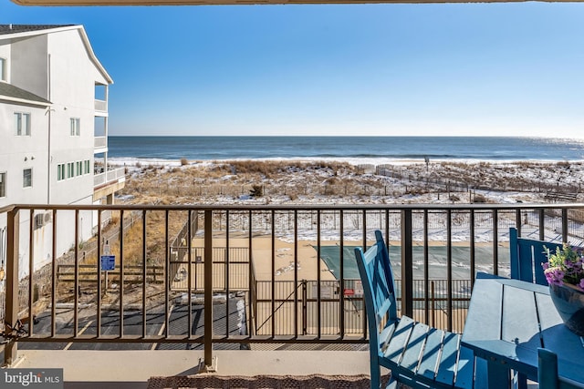 balcony with a beach view and a water view