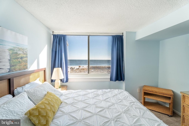 carpeted bedroom featuring a textured ceiling