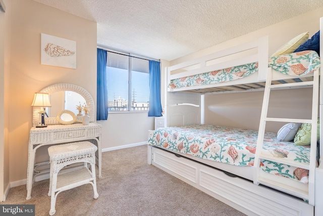 carpeted bedroom with a textured ceiling