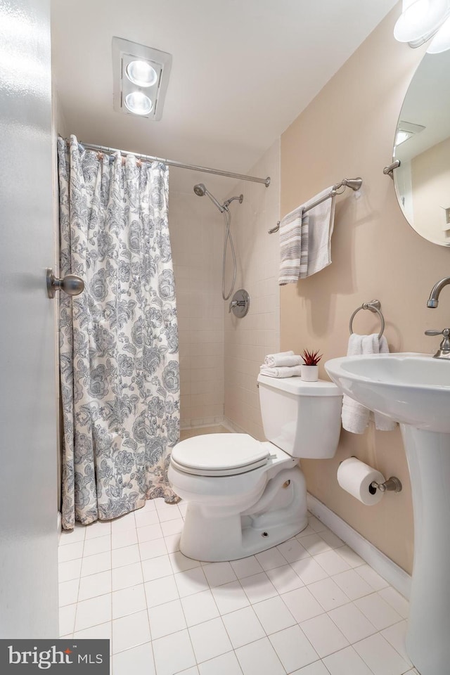 bathroom featuring toilet, walk in shower, and tile patterned floors